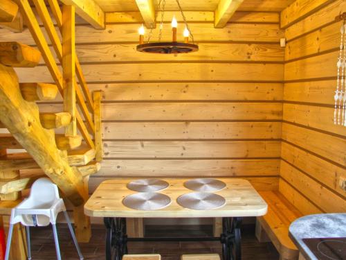a wooden room with a table in a sauna at Tranquil Lakefront holiday home in Lubrza