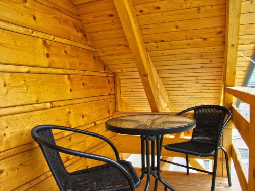 a small table and two chairs in a cabin at Tranquil Lakefront holiday home in Lubrza