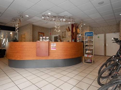 a store with a counter and some bikes in a room at Charming Hideaway Near Woods in Hellendoorn