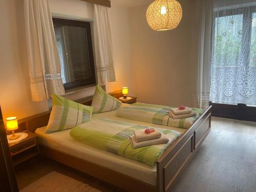 a bedroom with two beds with towels on them at Haus Käfersberg in Naturno