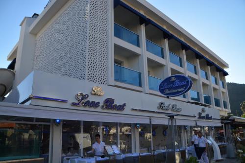 a building with a sign for a restaurant at Devamli Hotel in Marmaris
