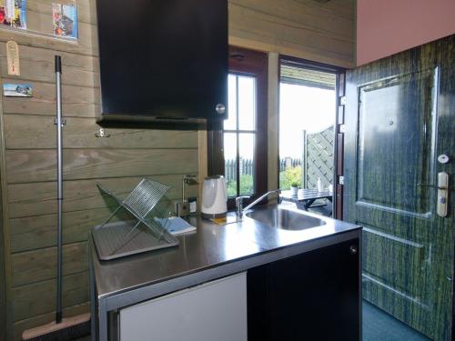 a kitchen with a sink and a counter top at Veluwe Retreat w Garden in Cisowo