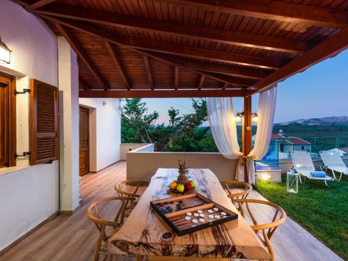 a table and chairs on a patio with a view at Villa in Crete with Private Pool & Beaches Nearby in Achlades