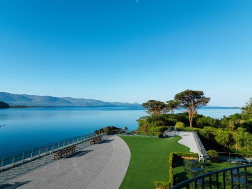 a walkway next to a body of water at Parknasilla Resort & Spa in Sneem