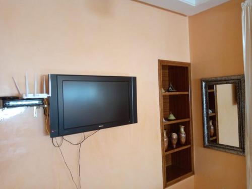 a flat screen tv hanging on a wall at Appartement agadir in Agadir