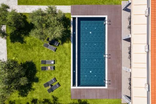 an overhead view of a swimming pool next to a building at Eightyfour Living with private pool in Chania