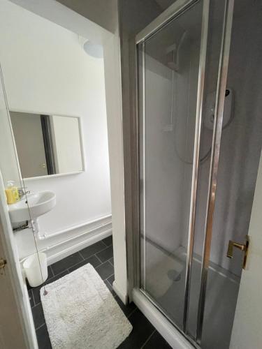 a bathroom with a shower and a sink at Entire Flat, Canterbury Centre - Free Parking in Kent
