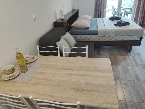 a room with two beds and a table and chairs at Deni09 in Pomer