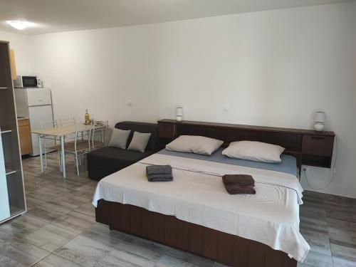 a bedroom with a large bed and a couch at Deni09 in Pomer