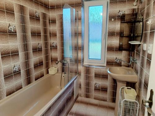 a bathroom with a tub and a sink at Chalupa u Martina in Vápenice