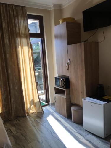 a kitchen with a sliding glass door and a window at hotel twins G&G in K'obulet'i