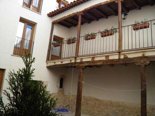 a balcony of a house with plants on it at Apartamentos Turísticos Peñafiel in Peñafiel