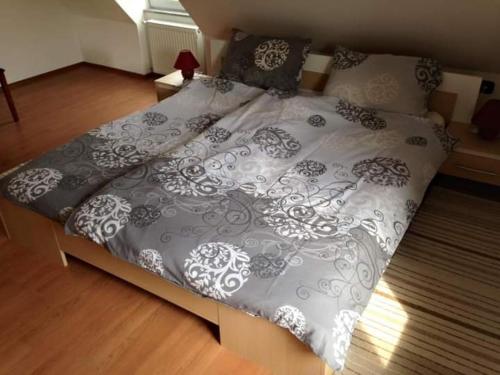 a large bed with a gray and white comforter at Apartmani Lucija in Vrata
