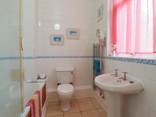 a bathroom with a white toilet and a sink at 382 on the Bay in Morecambe