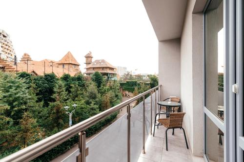 a balcony with a table and a view of a city at Arcadia Gold in Odesa