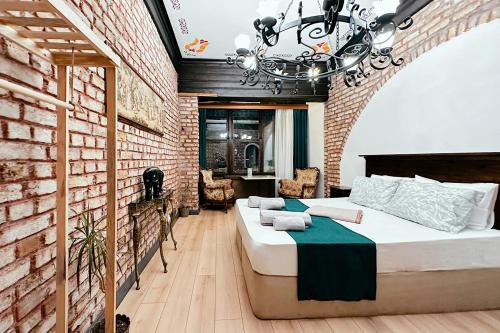 a bedroom with two beds and a brick wall at The Haliç Bosphorus in Istanbul