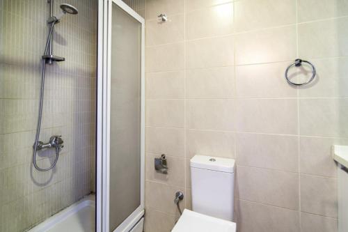 a bathroom with a toilet and a shower at Central Flat with Amazing City View in Atasehir in Istanbul