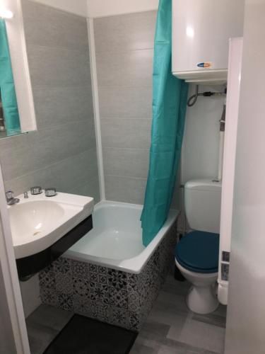 a small bathroom with a sink and a toilet at Studio duplex vue mer in Saint-Nic