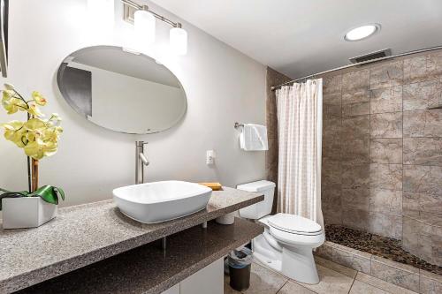 a bathroom with a sink and a toilet and a mirror at Kona Makai 6204 in Kailua-Kona