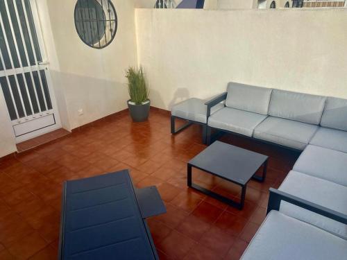 a living room with a couch and a table at Family Apartment in Orihuela