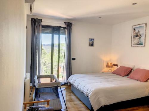 a bedroom with a large bed and a large window at Villa Barcelona en Olivella in Olivella