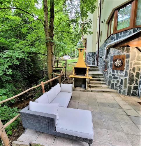 a patio with two white couches and a staircase at KOKICHE 4 Friends, Borovets in Borovets