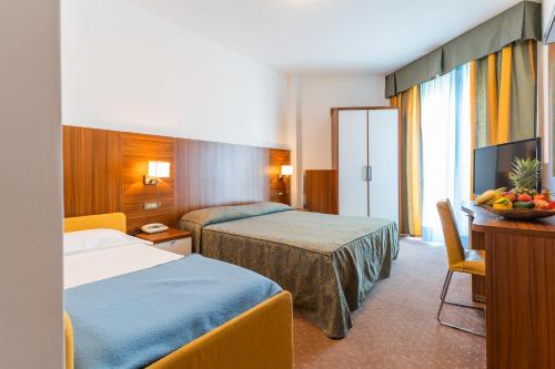 Postel nebo postele na pokoji v ubytování Hotel Touring