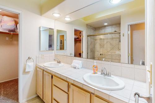 a bathroom with two sinks and a large mirror at Tucson National #8689 in Tucson