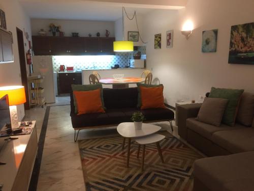 een woonkamer met een bank en een tafel bij Apartamento perto da Praia Coelha in Albufeira
