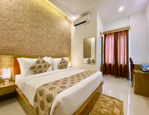 a bedroom with a large bed and a window at Arogyadham Wellness Retreat in Rishīkesh