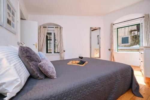 a bedroom with a large bed with a glass of wine at Apartment Galeriana Palace by Litto in Split