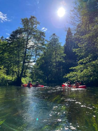 a group of people kayaking down a river at Domek w Gruszkach in Gruszki