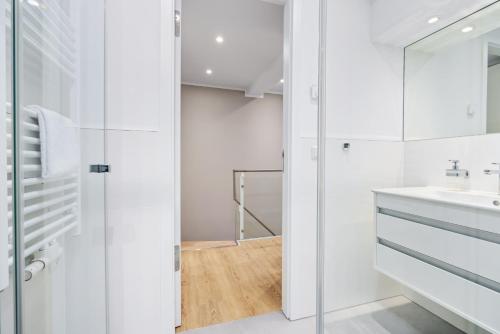 a white bathroom with a sink and a mirror at Strandresidenzen Binz-Prora Strandresidenzen Binz-Prora V0 3 in Binz
