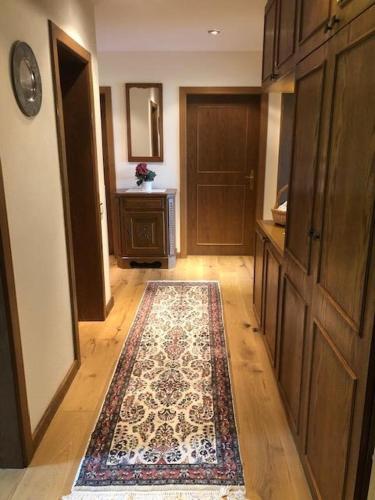 a hallway with a rug on the floor and a door at Tschengla Ferienwohnung in Bürserberg