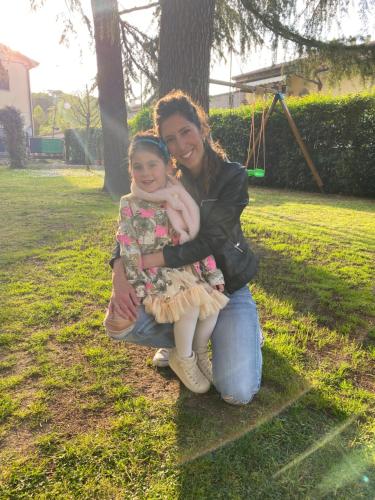 a woman holding a little girl in a park at Casa Maddalena in Casal Fiumanese