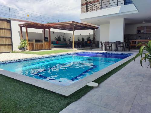 a swimming pool in the backyard of a house at Cabaña Milagro Bonito in Santa Marta