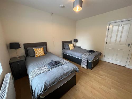 a bedroom with two beds and a door at Spacious ground floor suite comfortably sleeps up to eight in Halifax