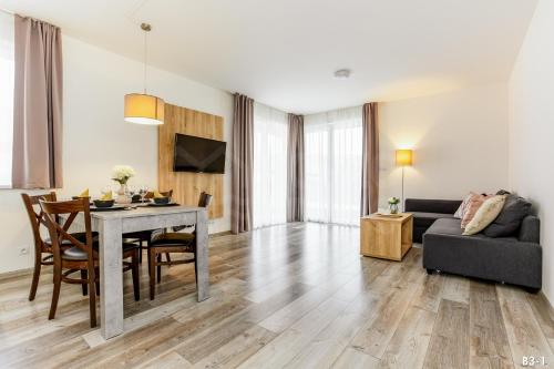 a living room with a table and a couch at KORZO Lipno in Lipno nad Vltavou