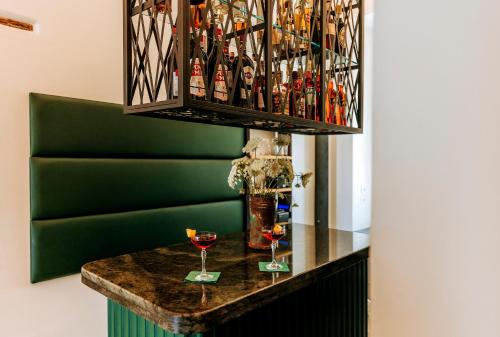a bar with two glasses of wine on a table at Faro Punta Imperatore in Ischia