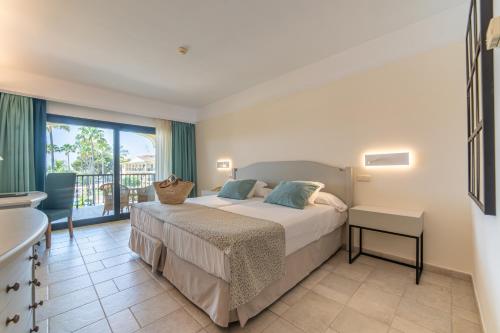 a bedroom with a bed and a balcony at CM Mallorca Palace - Only Adults in Sa Coma