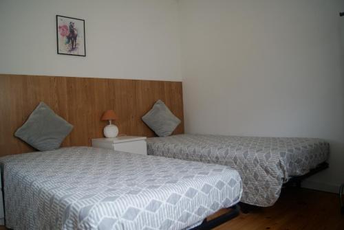 a hotel room with two beds in a room at Aguieira STAY in Castro Daire