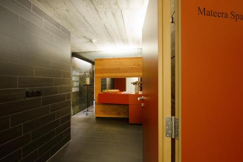 a hallway with a bathroom with a red sink at Familienhotel Mateera Gargellen / Montafon in Gargellen