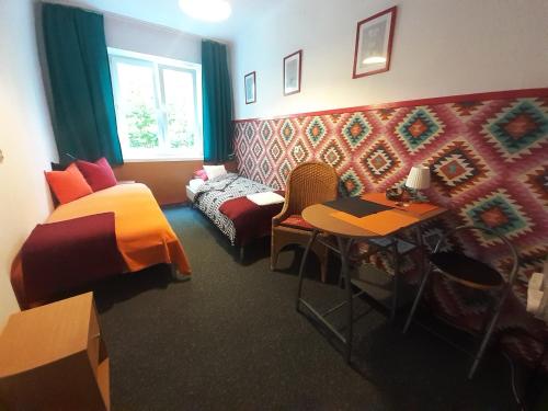 a bedroom with a bed and a table and a chair at Animrumru in Warsaw