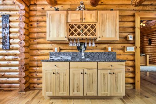 a kitchen with a sink in a log cabin at Spacious Twin Mountain Vacation Rental on 5 Acres! in Twin Mountain