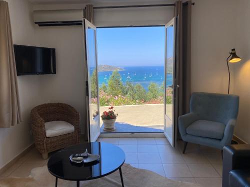 a living room with a door open to a patio at La Citadelle Appartements in Saint-Florent