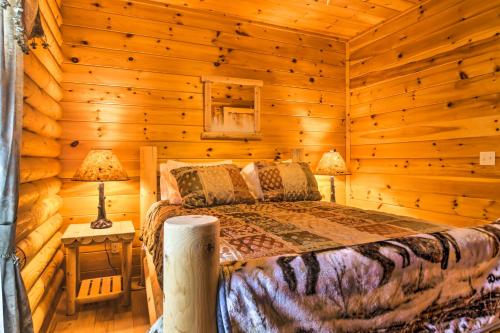 a bedroom with a bed in a log cabin at Spacious Twin Mountain Vacation Rental on 5 Acres! in Twin Mountain