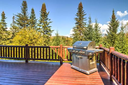 a grill on the deck of a house at Spacious Twin Mountain Vacation Rental on 5 Acres! in Twin Mountain