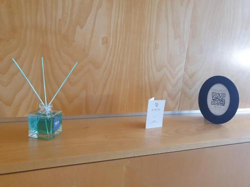 a wooden counter with a clock and a sign on it at Hotel Ristorante Al Mulino by LVG Hotel Collection in Alessandria