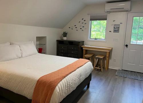 a bedroom with a bed and a desk and a window at The Loft at Little Bear in Frankfort