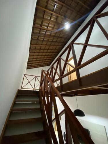 a wooden staircase in a room with a ceiling at Condomínio Village 4 Carneiros casa 40 in Tamandaré